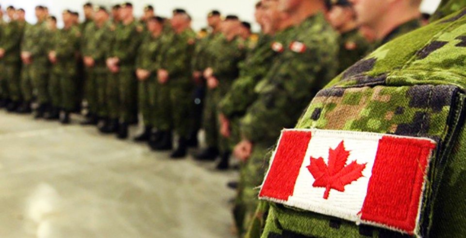 Canadian flag patch seen on shoulder of army fatigues