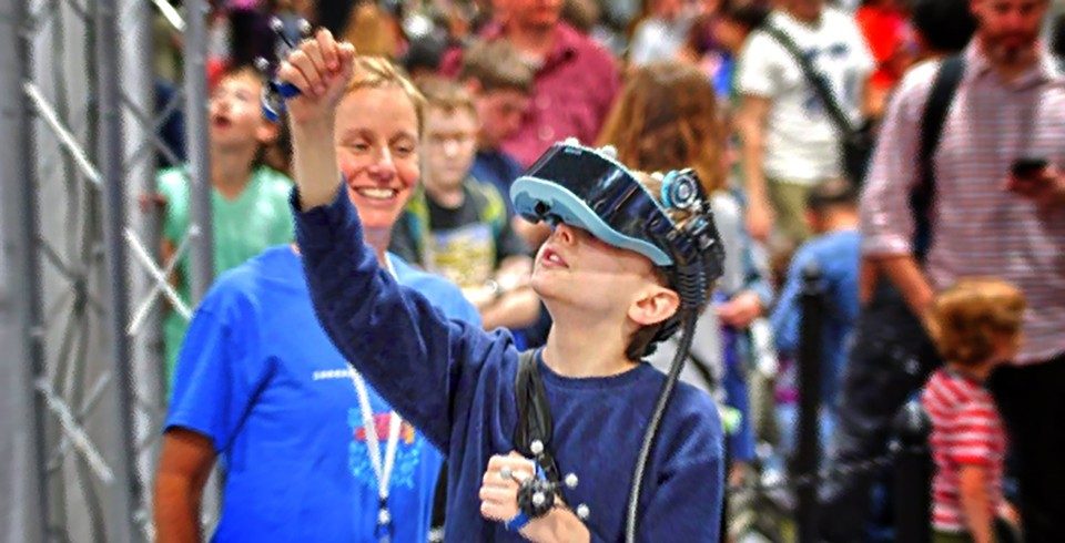 Little kid wearing a VR headset at a STEM event