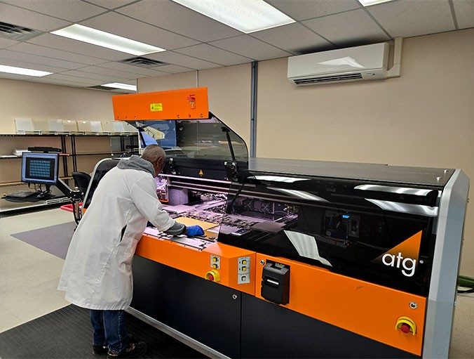 FTG circuits employee working at a large machine