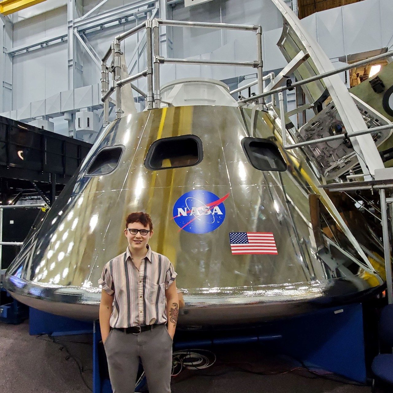 Engineer standing in front of Orion crew capsule