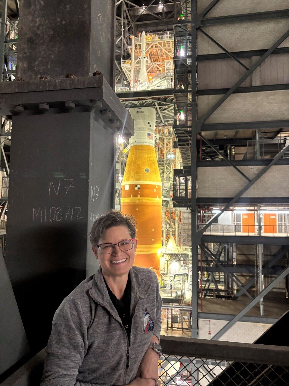 Lisa Akers with the Artemis II rocket with Orion