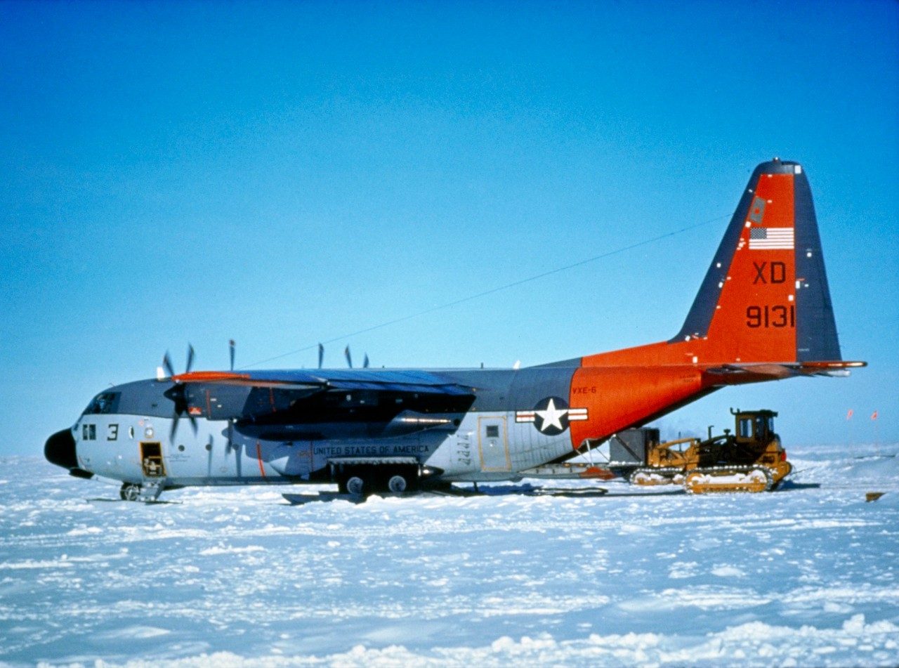 Cargo is being removed from a ski-equipped LC-130H Hercules. The LC-130H is designed for winter or arctic operations.
