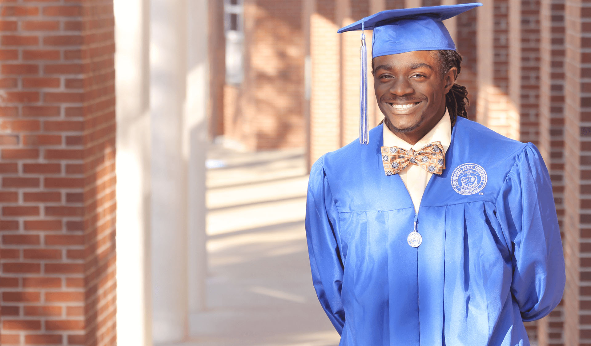 Troy graduated with a Bachelor of Science in Computer Science from Tennessee State University and a Master of Science in Systems Engineering from George Washington University. [Graduation photo]