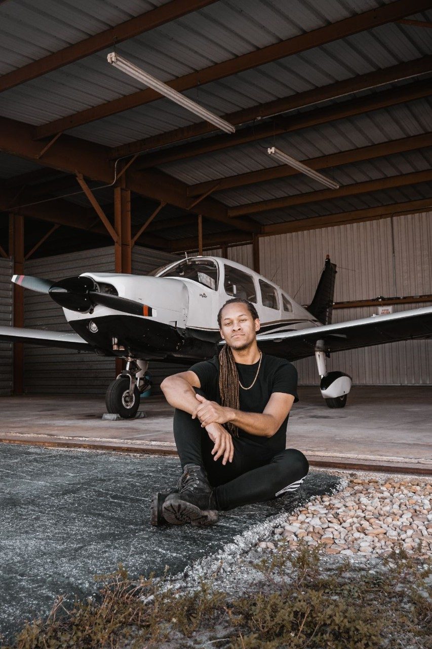 Joe in front of a piper aircraft