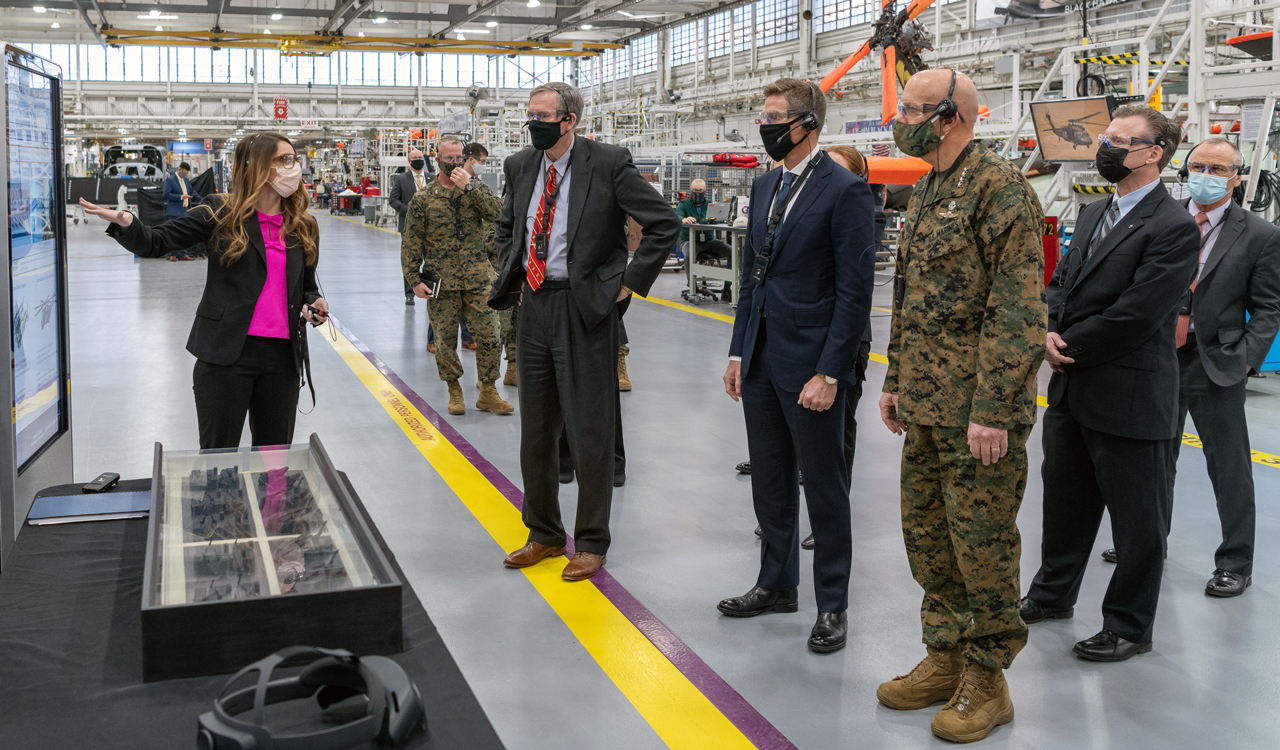 Elizabeth Pascetta (left), CH-53K Final Assembly project manager, demonstrates how the Sikorsky team applied Digital Transformation technologies to design the future facility layout to build heavy lift helicopters.  