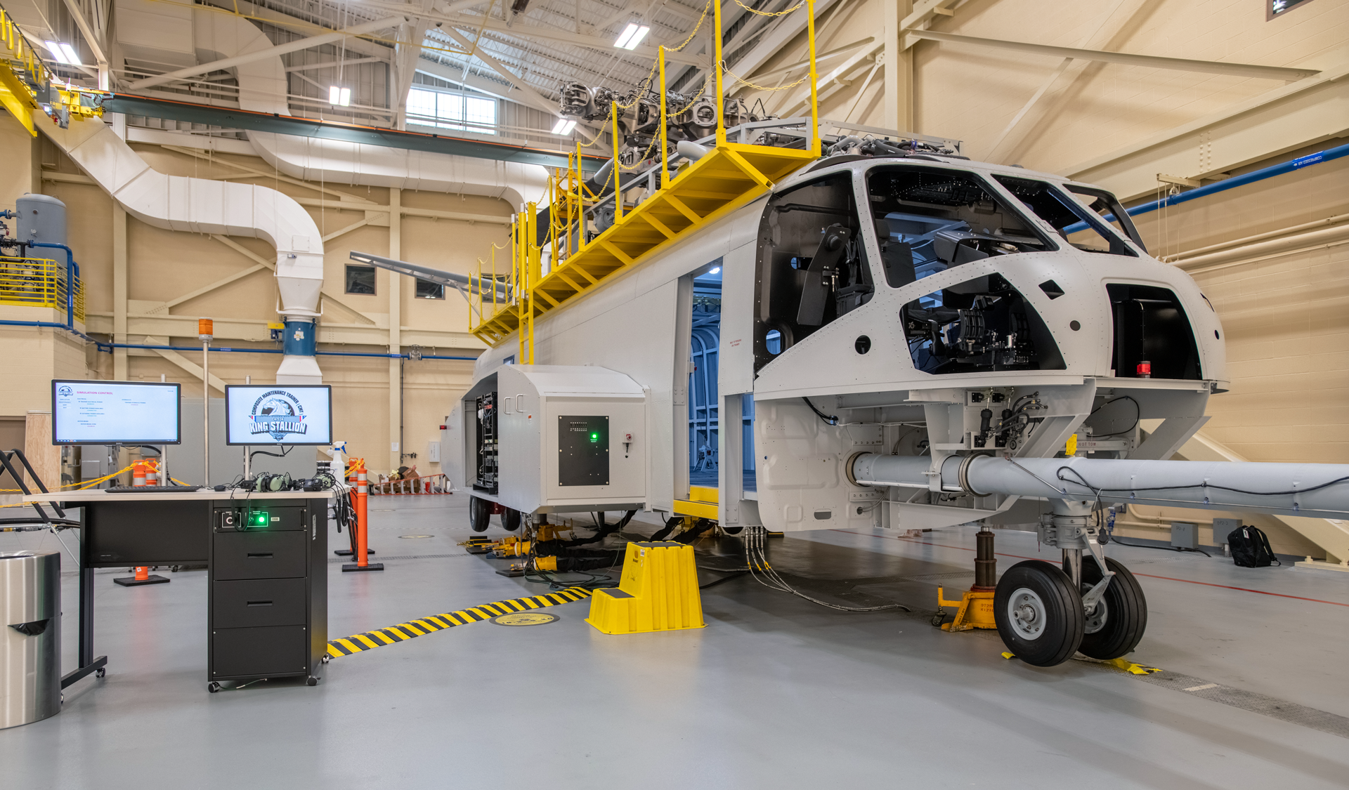 The Composite Maintenance Trainer (CMT) is a full-scale mock-up of the aircraft, allowing students to interact with the physical controls.