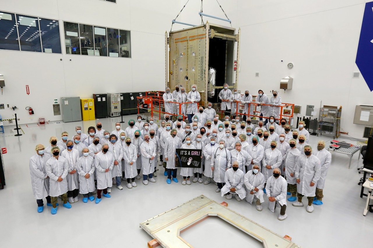 The GPS III government and industry team poses for a photo following core mate completion of GPS III Space Vehicle 10.