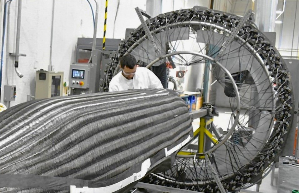 man working with large composite structure